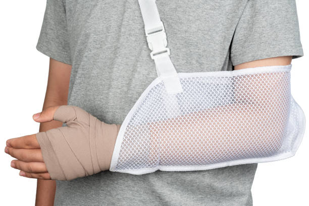 istock Close up hand with bandage isolate on white background as man arm injury concept and bandage hand arm sling. Asian boy with broken arm or hand dislocation isolated on white background. 1302941675