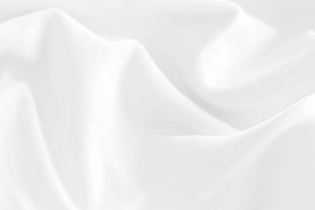 istock fashion textile Clean woven beautiful soft fabric abstract smooth curve shape decorative white background 1302941691