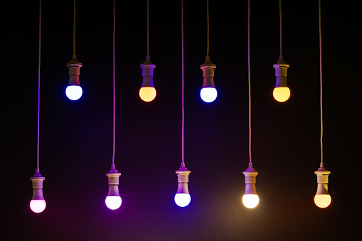 Lit Colorful Light Bulbs on Dark Background