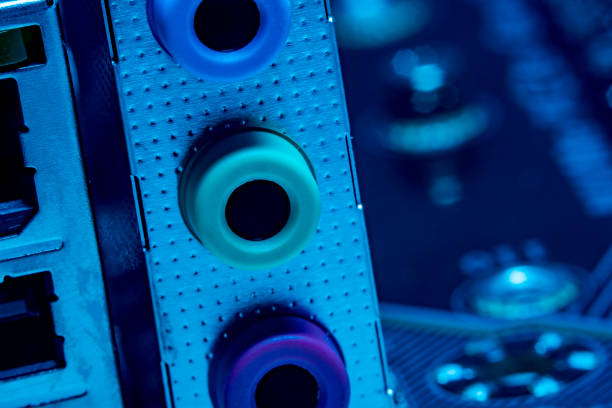 istock High tech dark background with elements of a computer motherboard in soft focus under high magnification. Audio jacks for connecting headphones and a microphone on the home computer board. 1302942905