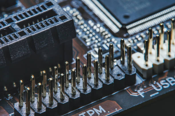 istock High tech dark background with elements of a computer motherboard in soft focus under high magnification. 1302942912