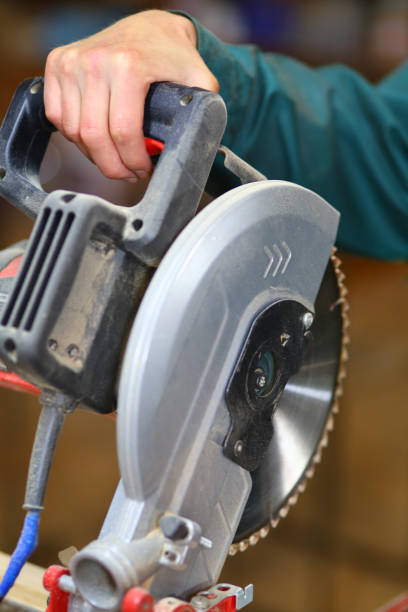istock Carpentry cutting machine and hand close-up 1302943330