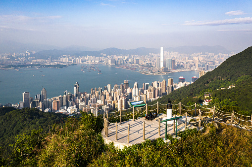 Viewing platform at the top of the High West Peak, next to the Victoria peak, with the famous Hong Kong island Central district skyline and Kowloon on the otherside of the harbor.