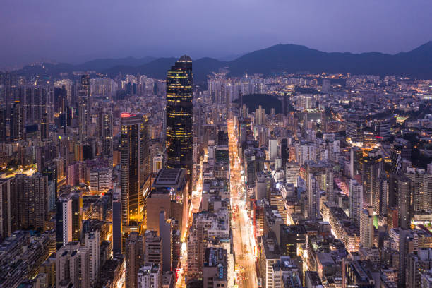 Purple sunset over the famous nathan road in the very crowded Mongkok district in Kowloon, Hong Kong Purple sunset over the famous nathan road in the very crowded Mongkok district in Kowloon, Hong Kong mong kok stock pictures, royalty-free photos & images