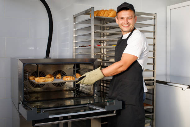 istock A young baker worker in a bakery is holding pastries 1302945190