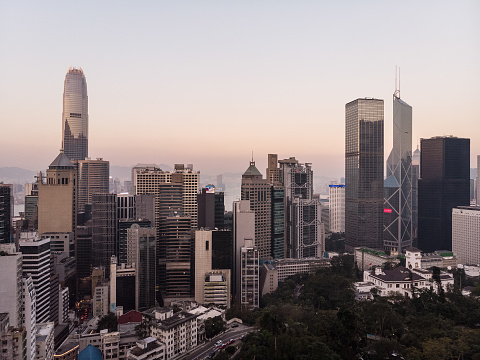 Aerial view of Hong Kong Central business district at sunset with the Government house in Hong Kong island, China.
