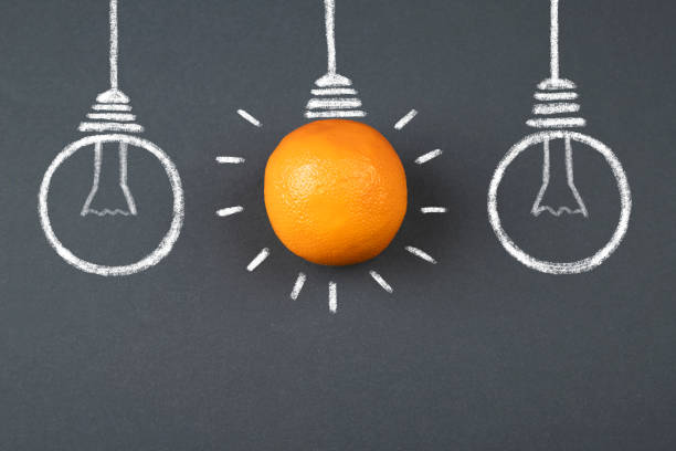 istock Light bulbs made of orange fruit 1302945862