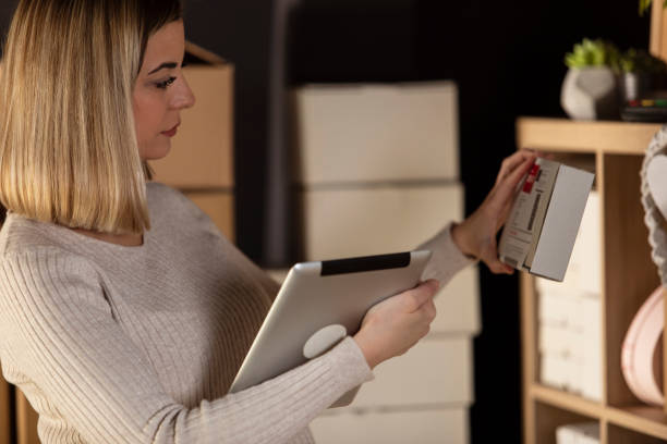 istock Female business owner checking a label on the package 1302946027