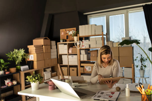 istock Checking her 'to do' list on a clipboard while sitting at the desk 1302946713