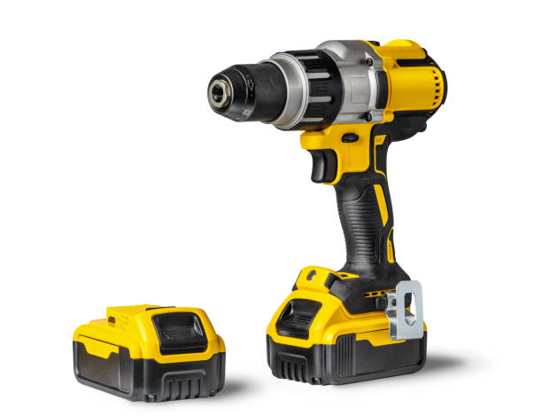 Yellow-black cordless Combi Drill Driver Hammer Drill and extra battery isolated on white background. Yellow-black cordless Combi Drill Driver Hammer Drill and extra battery isolated on white background. drill stock pictures, royalty-free photos & images