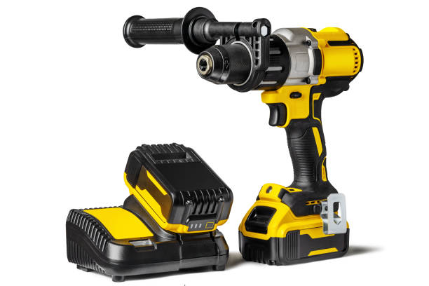 istock Yellow-black cordless Combi Drill Driver Hammer Drill and extra battery with charger isolated on white background. 1302946828
