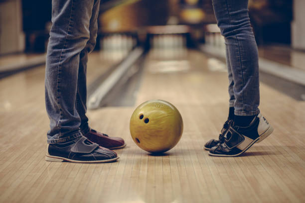 istock Couple standing in bowling  alley. 1302950224