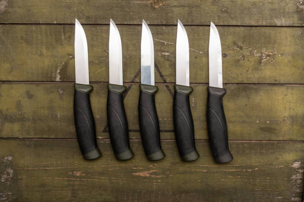 istock Several identical knives lying in a row. There are many knives on the table. Flat lay. 1302951204