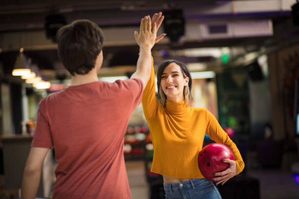 istock Young couple having fun in bowling alley. 1302951427