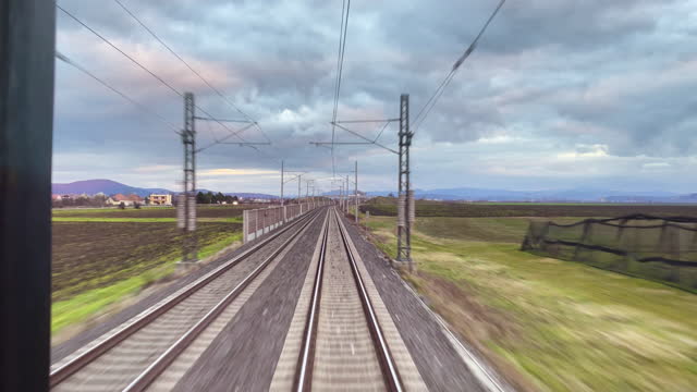 Fast speed moving train driver POV 4K footage. Transportation, traveling and cargo industry concept UHDTV video.