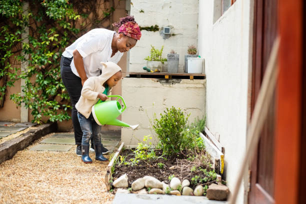 istock Boy helping mom in the garden 1302954021