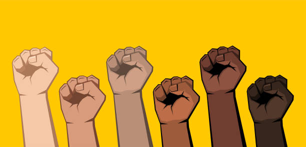 istock Six raised clenched fists of different shades. 1302954539