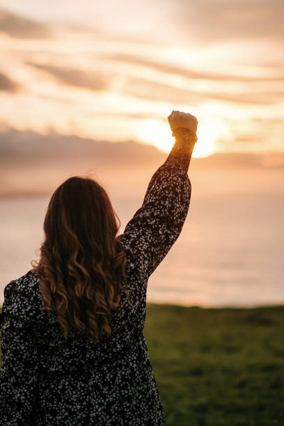 istock Young woman with high fist 1302955355