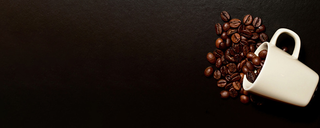 Banner with raw coffee beans and espresso cup on the table. Hot drinks backgrounds