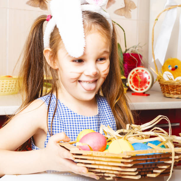 istock children wearing bunny ears on Easter day 1302956501