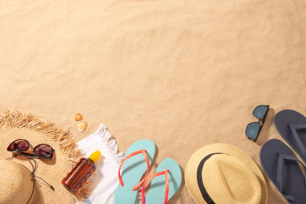 istock Male and female beach accessories on the sand with copy space 1302956548