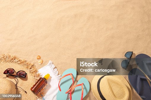 istock Male and female beach accessories on the sand with copy space 1302956548