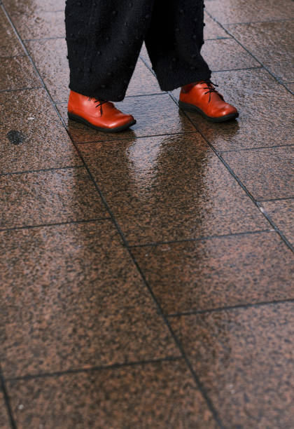 istock Red shoes on pavement. 1302958017