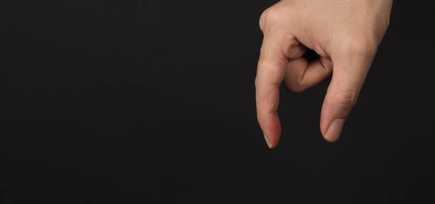 istock Man hand holding gestures and empty sign, isolated on black background. copy space 1302958184
