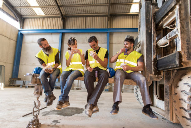 istock Construction workers take a break snacking on the blades of a giant forklift 1302960981