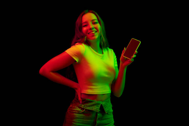istock Caucasian woman's portrait isolated on black studio background in multicolored neon light 1302960996