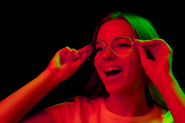 istock Caucasian woman's portrait isolated on black studio background in multicolored neon light 1302961003