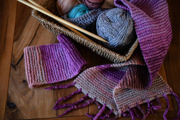 istock Accessories for knitting in basket ( yarn, needles) and scarf 1302962222