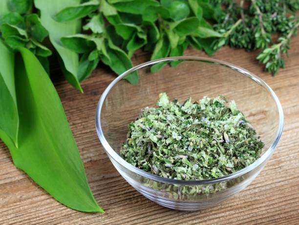 Homemade herbal salt made from various herbs. Spices contain cut wild garlic, oregano, rosemary and lavender flower with sea salt.