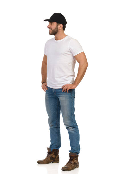 Casual Young Man Is Standing With Hands On Hip And Looking Away