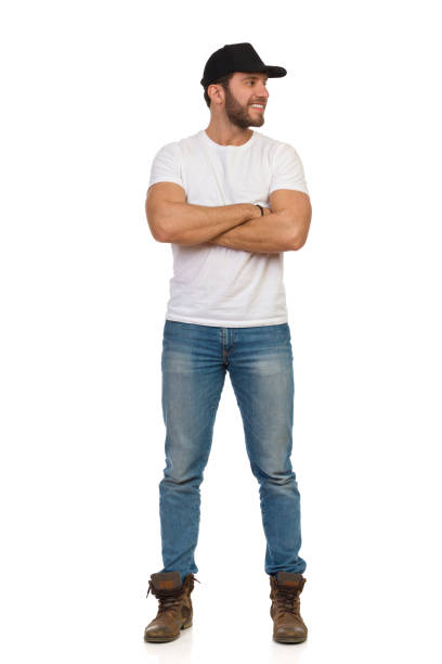 istock Casual Smiling Man In Black Cap Is Standing And Looking Away 1302964968