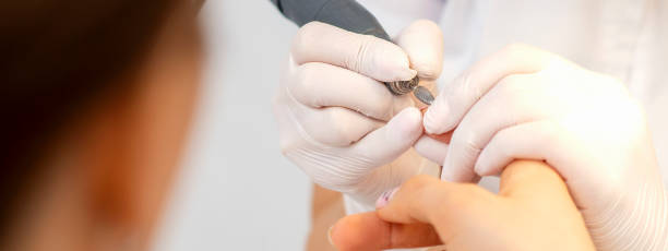 istock Manicure master removes nail polish 1302966393