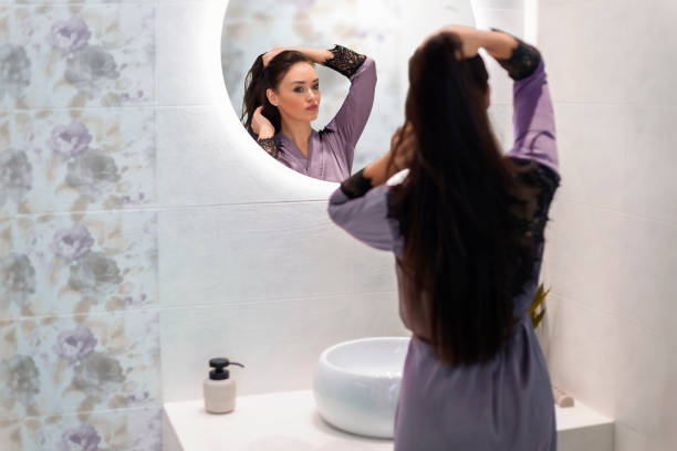 istock Woman in the bathroom reflection in the mirror 1302967943