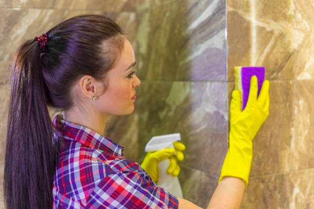 istock Woman cleans tiles with a Scrub sponge and detergent 1302968071