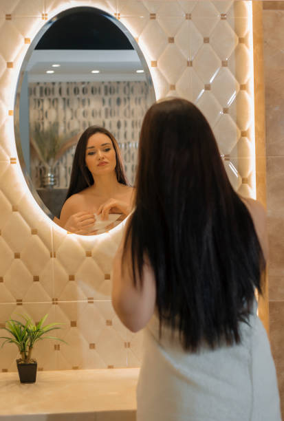 istock Woman in the bathroom reflection in the mirror 1302968115