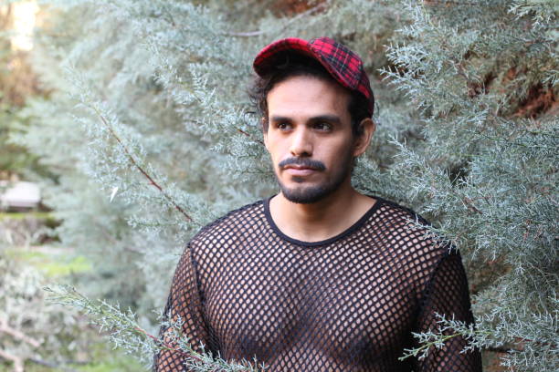 istock Man wearing see through mesh shirt 1302968447