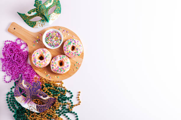 istock Mardi gras carnival doughnuts and beads, holiday celebration, baking, top view 1302968769