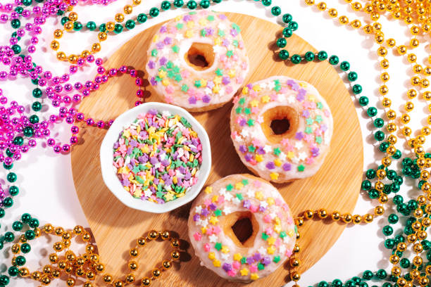 istock Mardi gras carnival doughnuts and beads, holiday celebration, baking, top view 1302968829