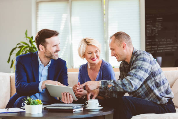 istock Mature couple talking with financial advisor 1302972805