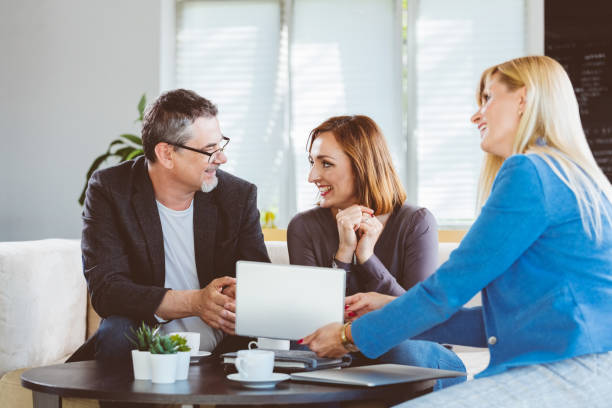 istock Mature couple talking with financial advisor 1302973358