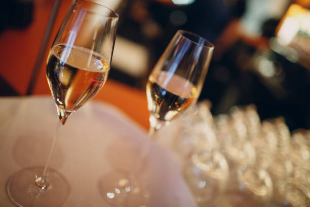 istock Two glasses of champagne with bubbles on a table in a restaurant 1302975016