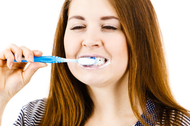 istock Woman brushing cleaning teeth. 1302977859