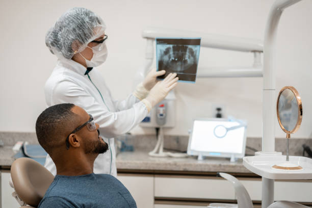 istock Dentist shows dental x-ray 1302979597