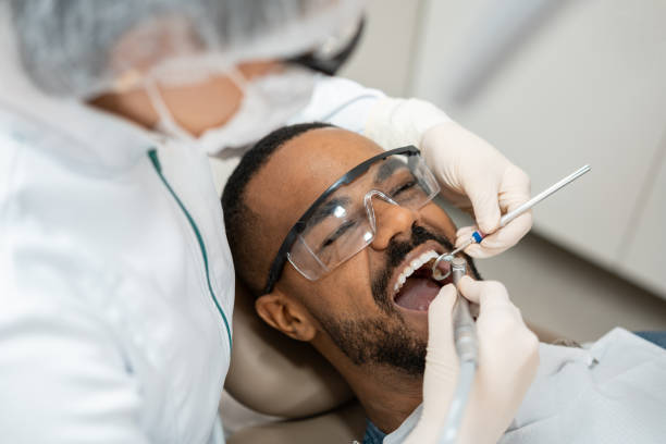 Dentist using dental drill stock photo