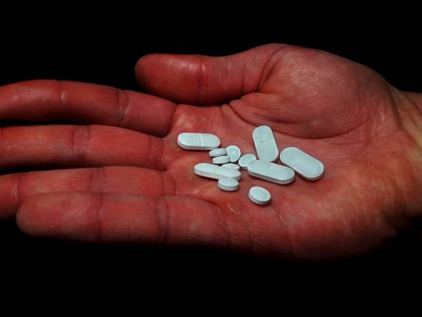 istock Antidepressants pills on man palm on black background 1302979822