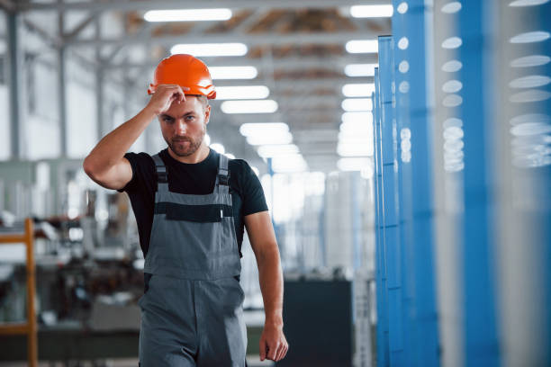 istock Taking off hard hat. After the work. Industrial worker indoors in factory. Young technician 1302979941